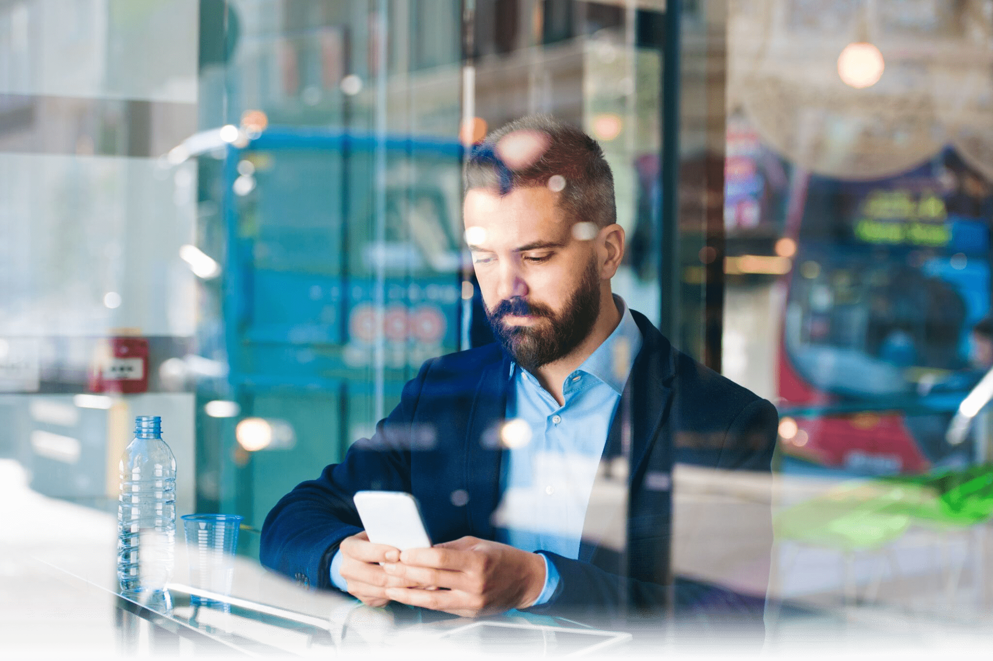 iStock-493632578-man-holding-phone-in-cafe